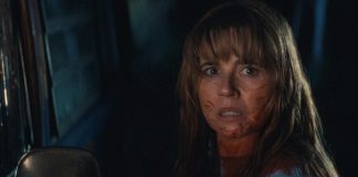 Pam Voorhees (Linda Cardellini) stands next to a truck, covered in blood, in Crystal Lake