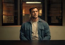 ‘Reacher’ Season 4, Episode 8 Recap & Review: An Action-Packed Finale Makes Up for a Slow Start Reacher sits at a police desk in Reacher Season 4